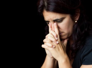 Woman in humble Catholic prayer